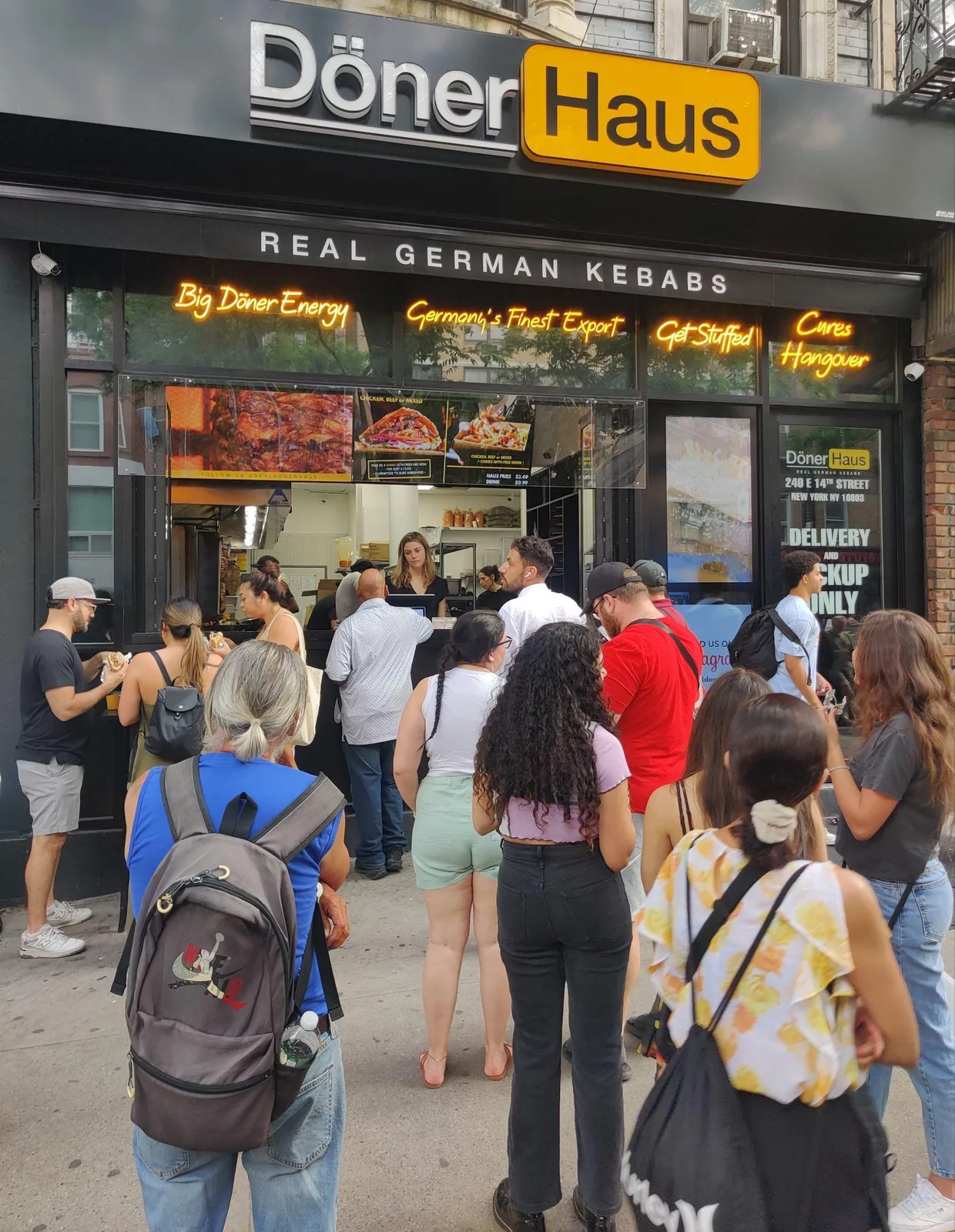 A line of customers outside a German döner shop on a New York sidewalk