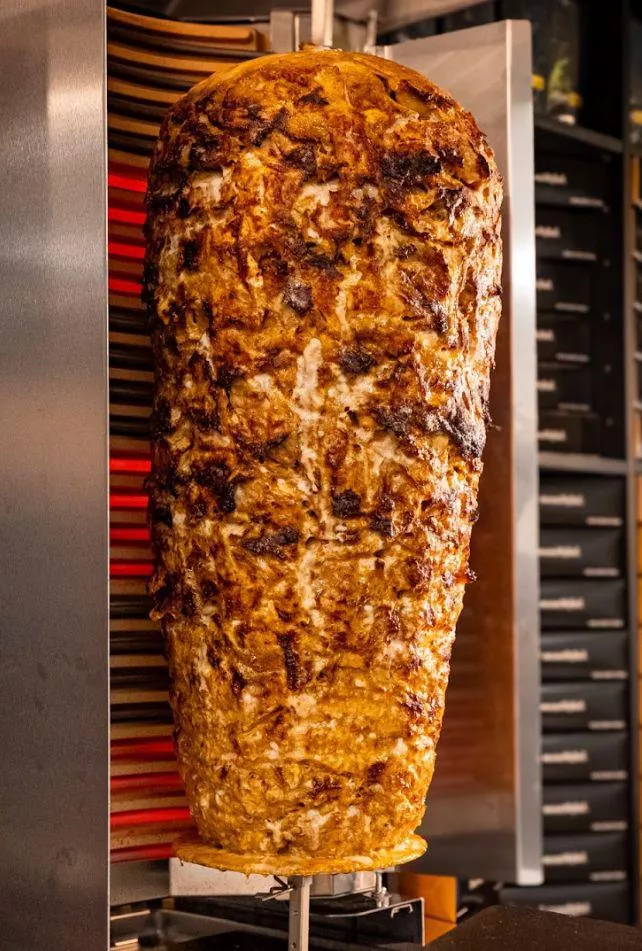 Close view of the browned outer edge of a vertical döner spit